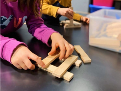 2 kids buiulding with KEVA planks