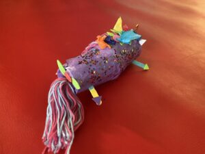 Back of a unicorn made of cup, yarn, and construction paper
