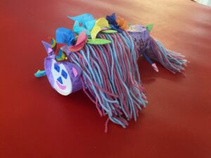 Unicorn made of cup, yarn, and construction paper